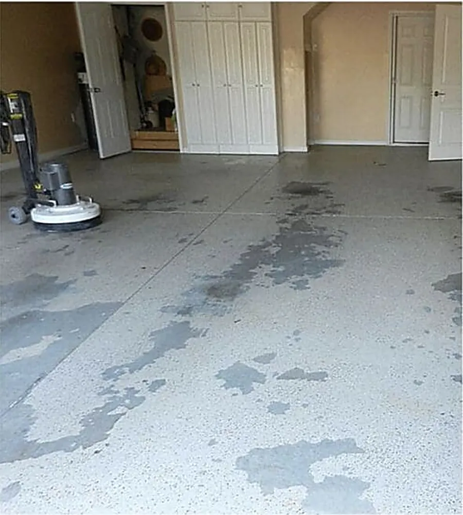 Floor grinder opening bare concrete before an epoxy coating is applied