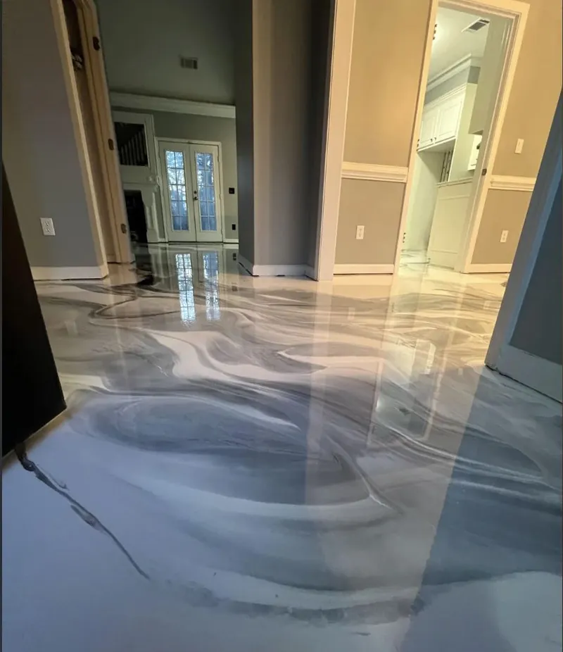 Metallic epoxy floor with pearl and charcoal swirl pattern
